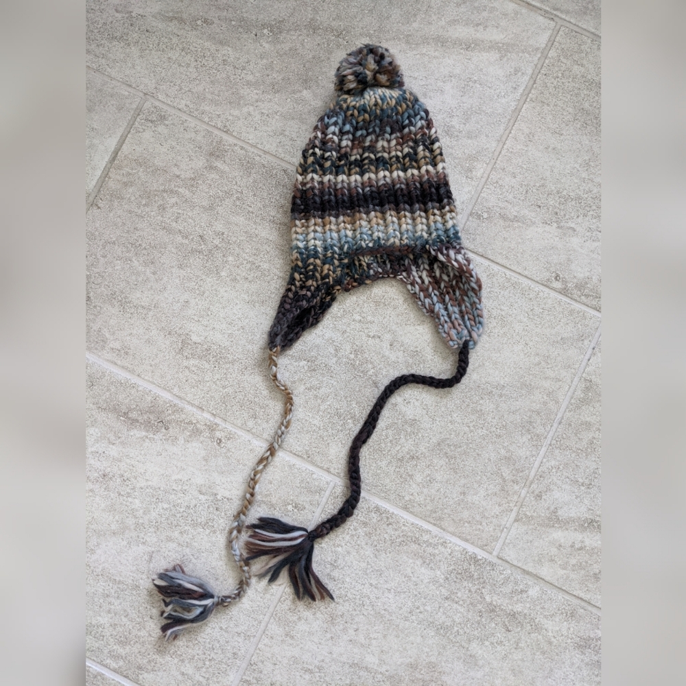Brown winter hat with pom-poms
